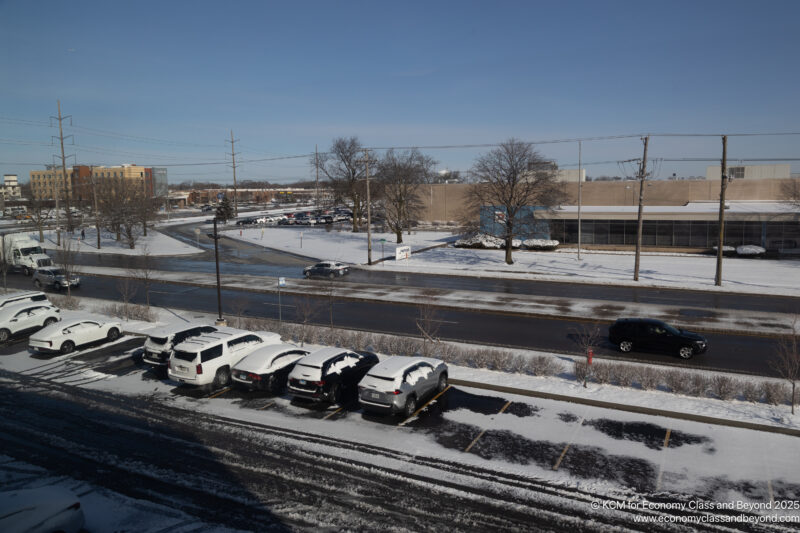 a parking lot with cars and snow