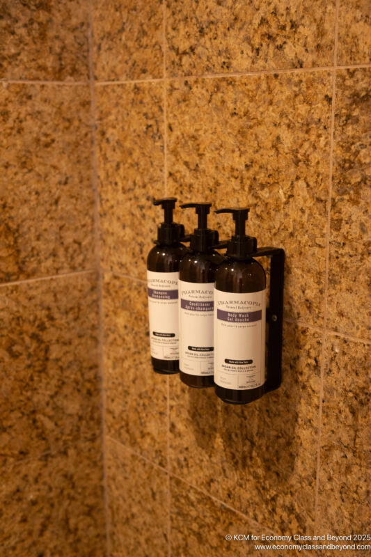 a group of bottles of liquid soap on a wall