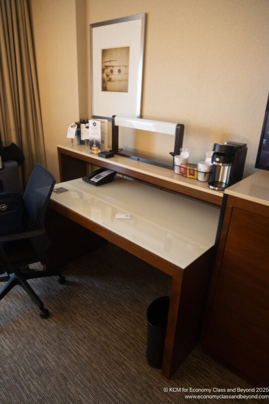 a desk with a chair and a television