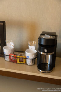 a coffee machine and cups on a table