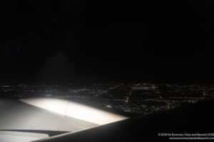 an airplane wing and lights at night