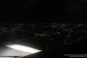 an airplane wing and a city at night