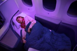 a woman sleeping in a plane