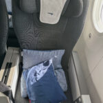 a seat with pillows and a towel on it