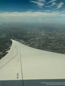 an airplane wing and a city