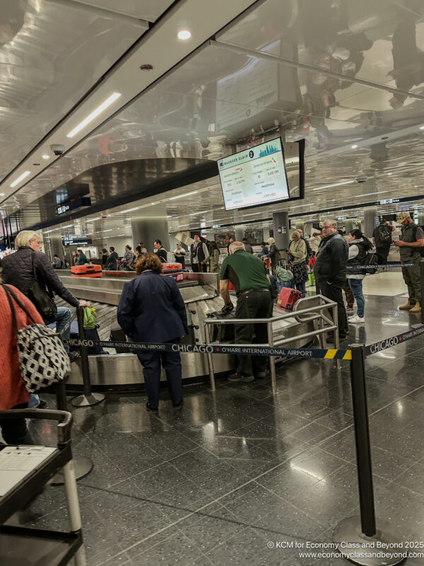 a group of people standing around a conveyor belt