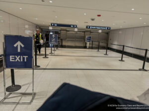 a man standing in a hallway with a sign