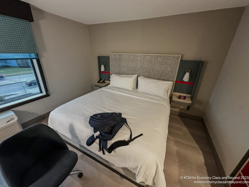 a bed with a backpack on it