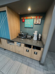 a kitchen counter with a microwave and a sign