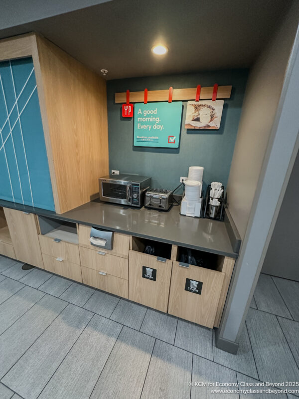a kitchen counter with a microwave and a sign