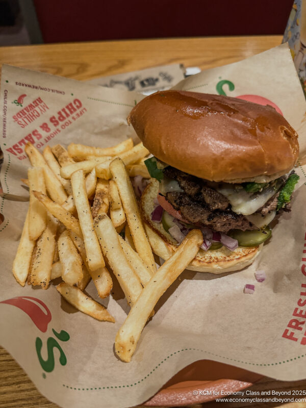 a burger and fries on a paper wrapper
