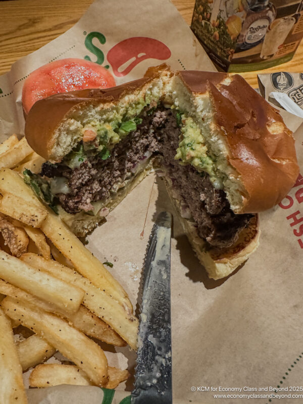 a burger and fries on a paper wrapper