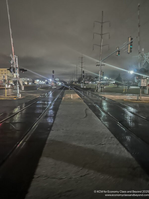 a train tracks on a wet street