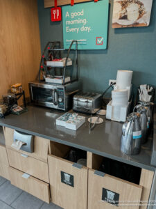 a counter with a microwave and a sign