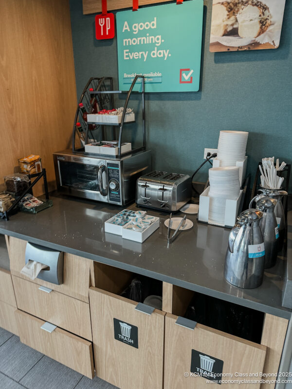 a counter with a microwave and a sign