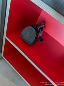 a red shelf with a vacuum cleaner