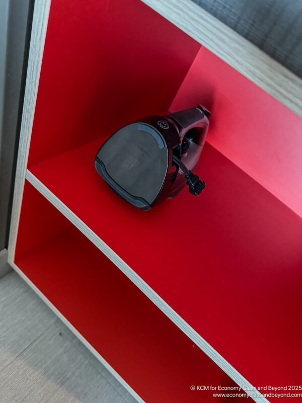 a red shelf with a vacuum cleaner