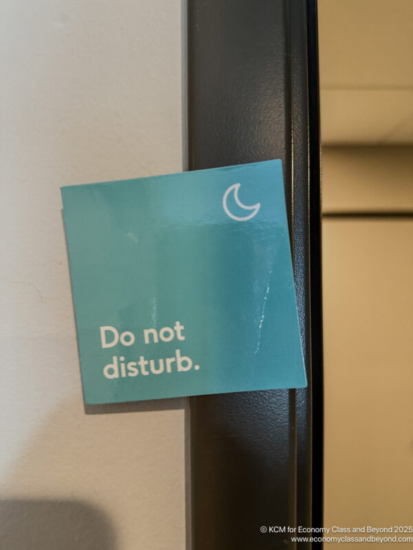 a blue square sign on a black frame