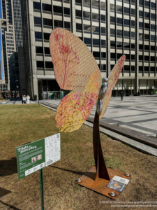 a statue of a butterfly in a city