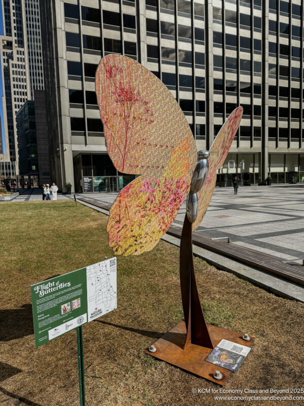 a statue of a butterfly in a city