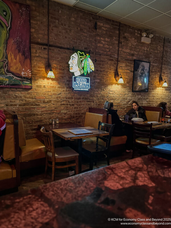 a group of people sitting at tables in a restaurant