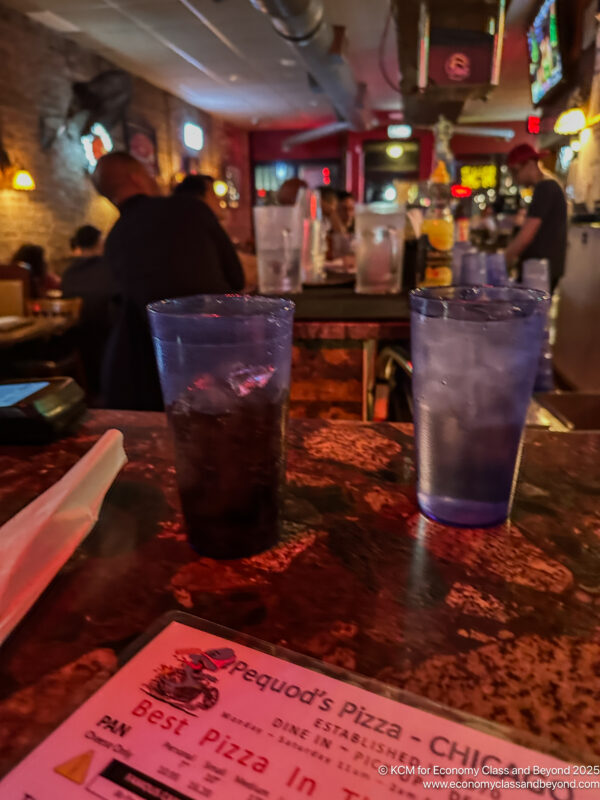 a couple of glasses of liquid on a table
