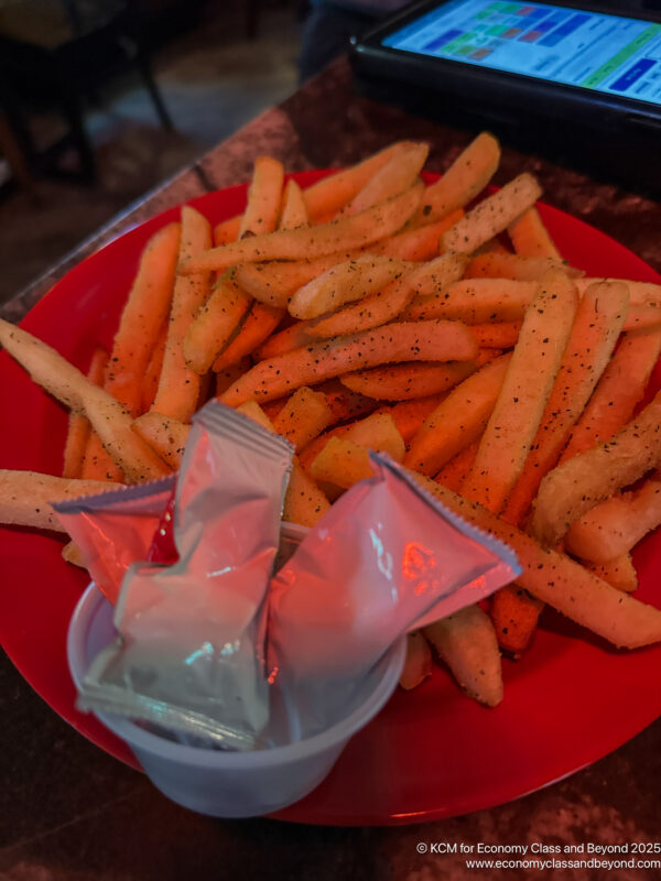 a plate of french fries and condiments