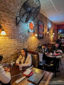 a group of people sitting at tables in a restaurant