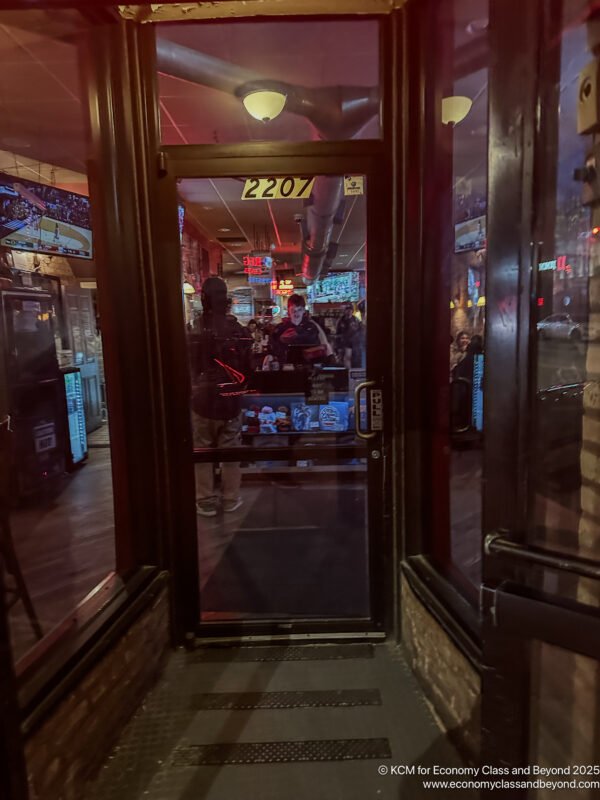 a glass door with a person standing in front of it