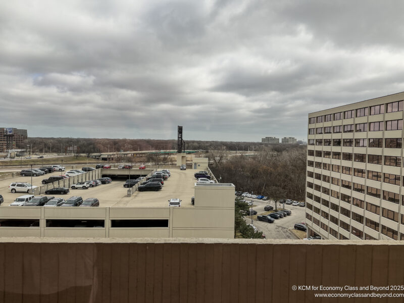 a parking lot with cars and buildings in the background
