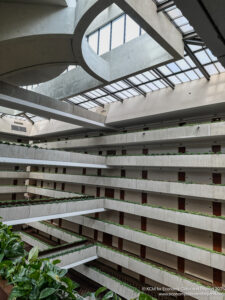 a building with many floors and plants