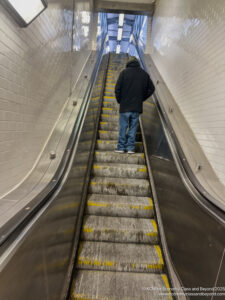 a man standing on an escalator