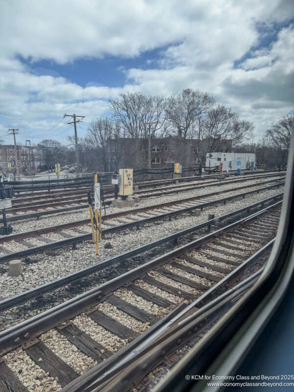 train tracks with a view of trees and buildings