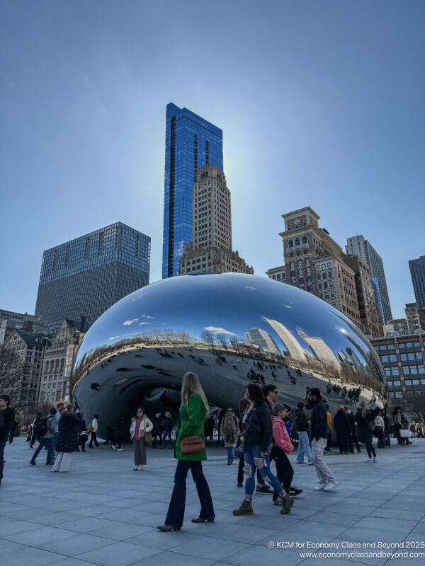a group of people walking in Millennium Park