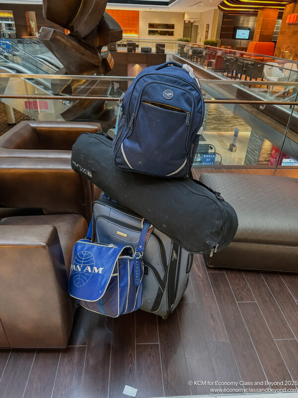 a stack of luggage on a wood floor
