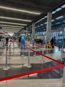 a red rope around a line in a airport