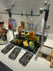 a glass shelf with food and utensils on it