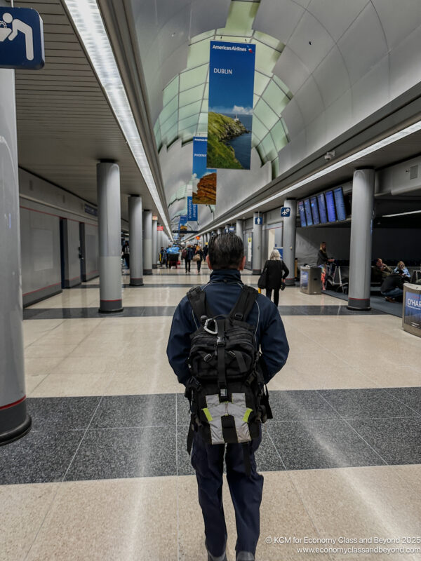 a man in a backpack in a hallway