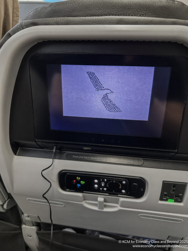 a screen on the seat of an airplane