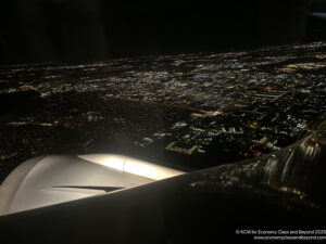 an airplane wing and a city at night