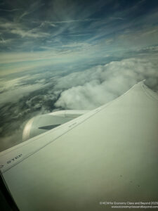 a wing of an airplane above clouds
