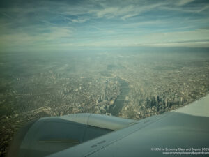 an airplane wing and wing of a city