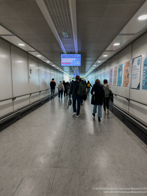 a group of people walking in a hallway