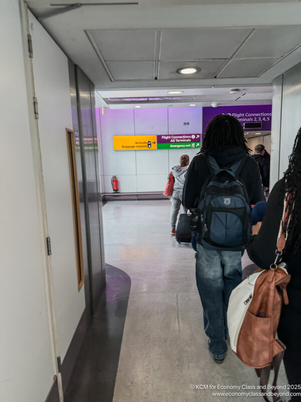 a group of people walking in a hallway