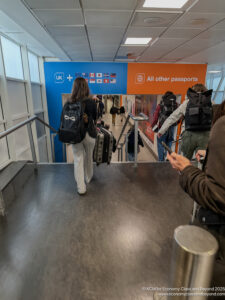 people walking down a walkway with luggage