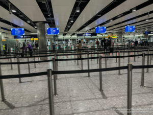 a group of people standing in a line in an airport