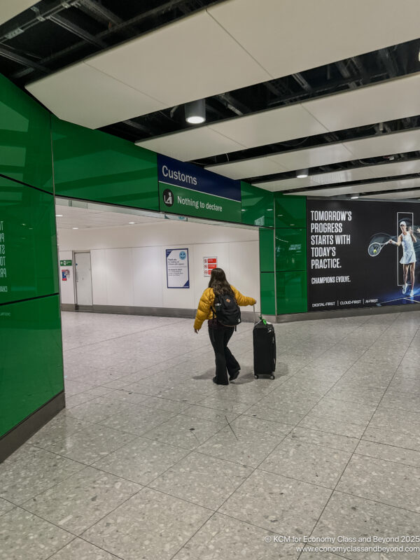 a woman walking with luggage in a airport