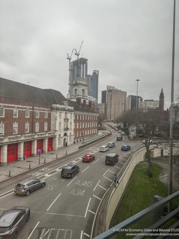 a street with cars and buildings in the background