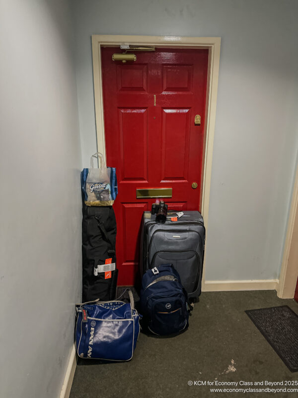 a red door with luggage on it