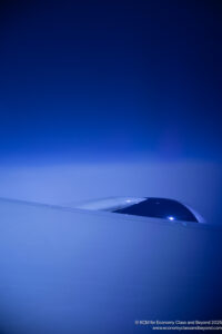 a plane wing with a blue sky